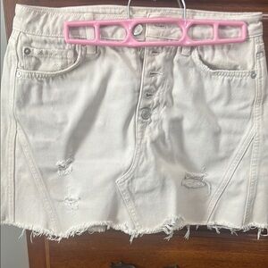 Distressed Cream Denim Skirt with buttons in front of the Jean skirt